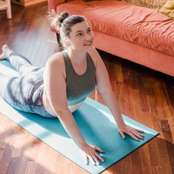 A person feeling energetic and stretching lightly in a modern, bright space.